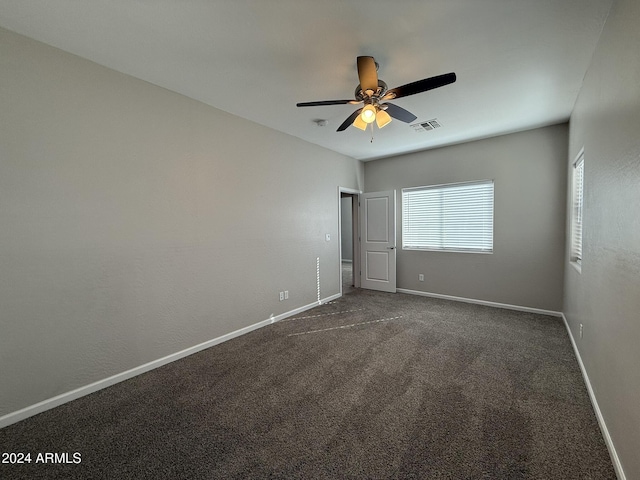 unfurnished bedroom featuring dark colored carpet and ceiling fan