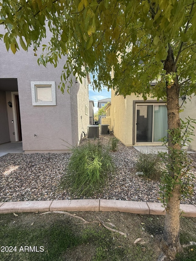 view of side of property featuring a pergola and cooling unit