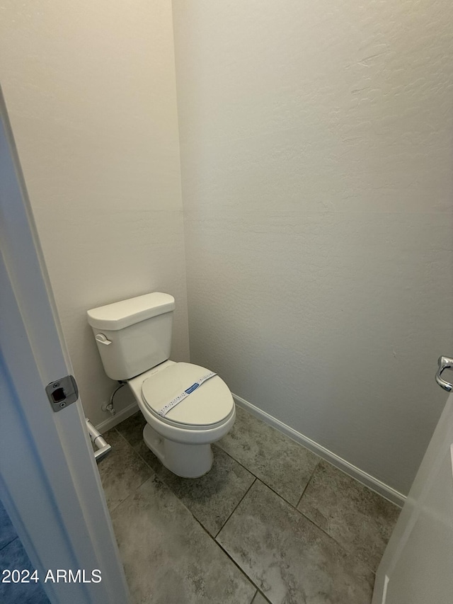 bathroom featuring tile patterned flooring and toilet