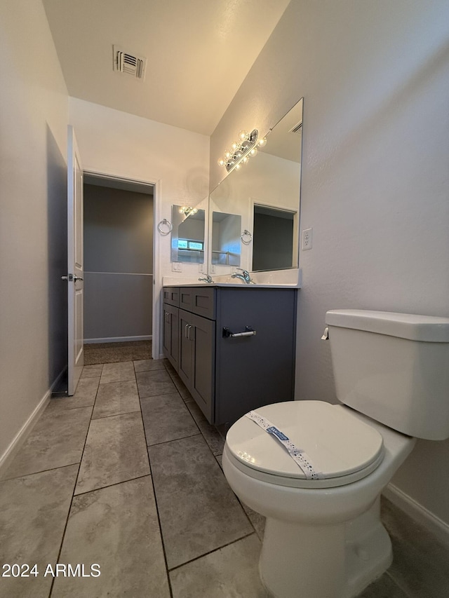 bathroom featuring tile patterned floors, vanity, and toilet