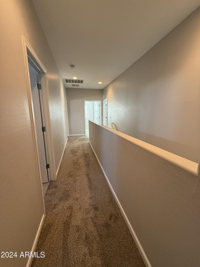 hallway with carpet floors