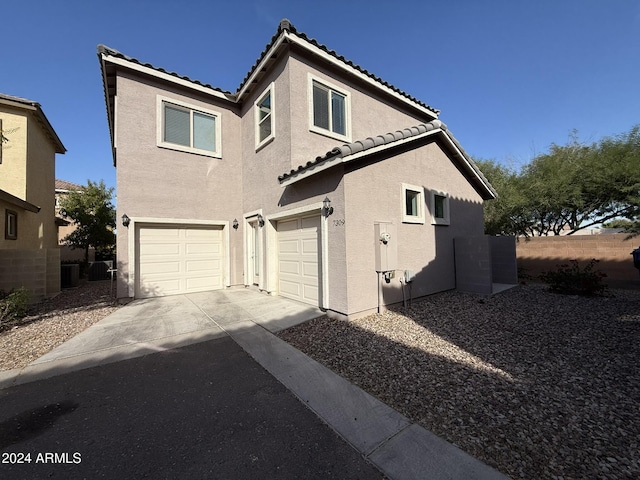 exterior space featuring a garage and central AC unit