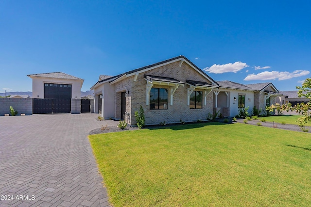 view of front of home with a garage and a front lawn