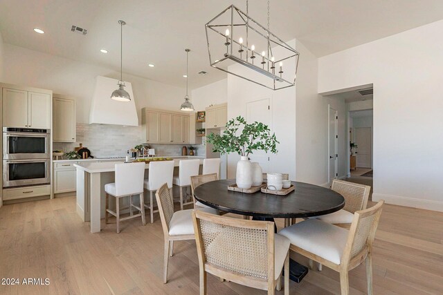 dining room featuring a notable chandelier and light hardwood / wood-style floors