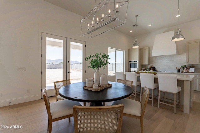 dining space featuring french doors and light hardwood / wood-style floors