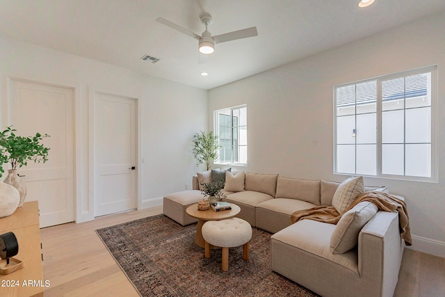 living room featuring ceiling fan and light hardwood / wood-style flooring