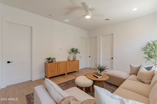 living room featuring light wood-type flooring and ceiling fan