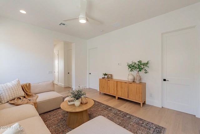 living room featuring ceiling fan and light hardwood / wood-style floors