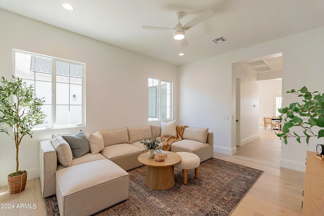 living room with ceiling fan and light wood-type flooring