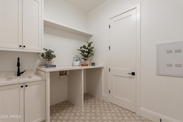 washroom featuring sink, hookup for a washing machine, and cabinets