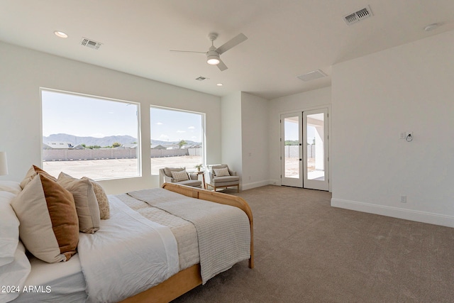 carpeted bedroom with ceiling fan, access to exterior, french doors, and multiple windows