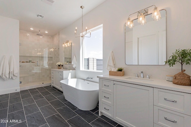 bathroom featuring a notable chandelier, shower with separate bathtub, double sink vanity, and tile patterned flooring