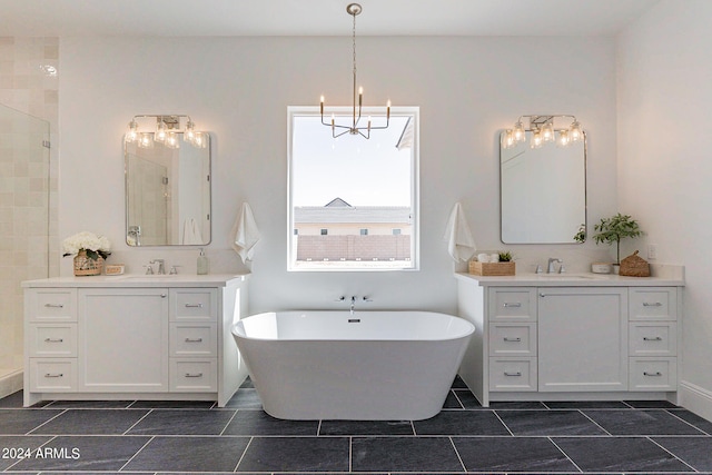 bathroom with dual vanity, a bathtub, and tile patterned flooring