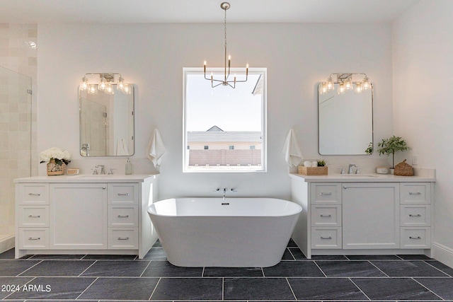 bathroom with vanity, shower with separate bathtub, and a chandelier