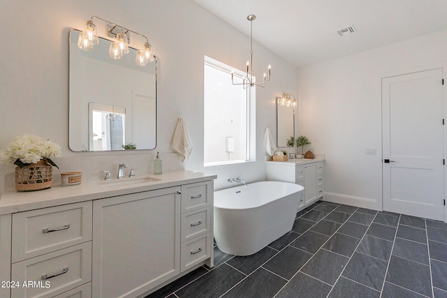 bathroom with a tub, tile patterned floors, and dual bowl vanity