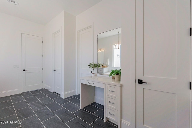 bathroom with tile patterned floors and vanity