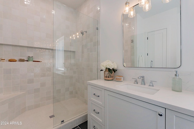 bathroom featuring vanity and a shower with shower door