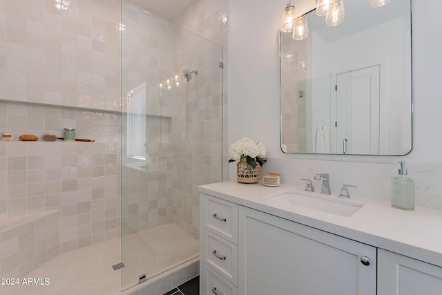 bathroom featuring vanity and tiled shower