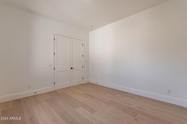 spare room with light hardwood / wood-style floors