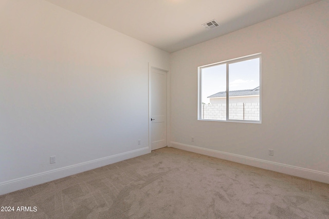 unfurnished room with light colored carpet