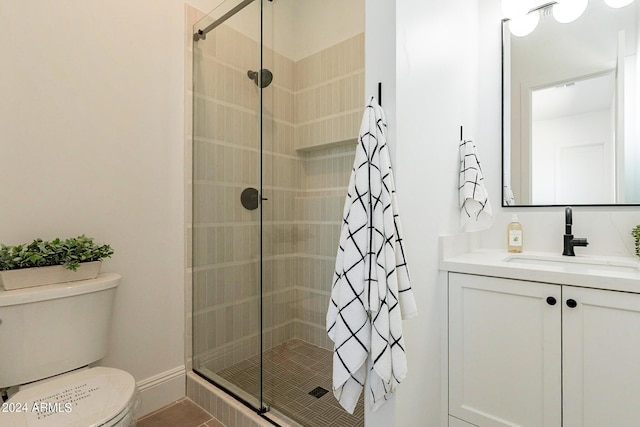 bathroom with a shower with door, toilet, tile patterned floors, and vanity