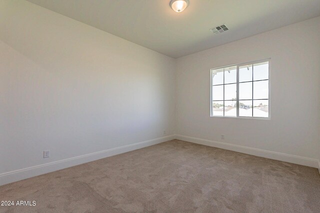 empty room featuring light carpet