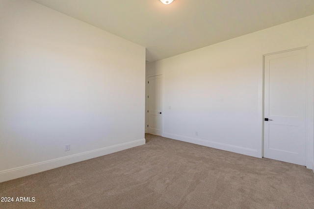 empty room with light colored carpet