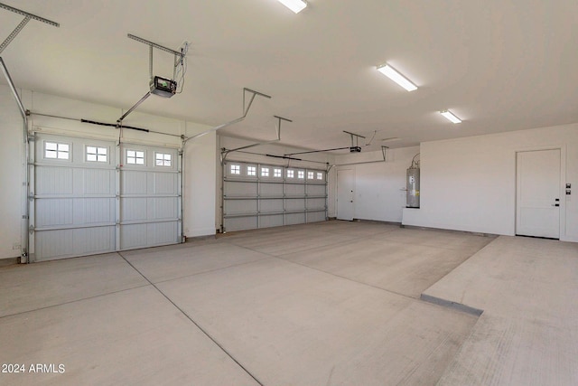 garage featuring a garage door opener and electric water heater