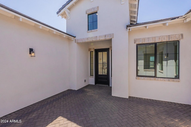 entrance to property with a patio