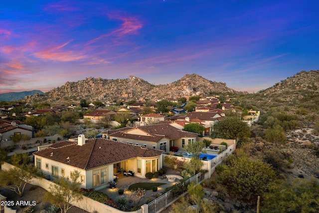 aerial view at dusk featuring a mountain view