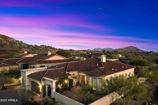 view of front of property featuring a garage and a mountain view