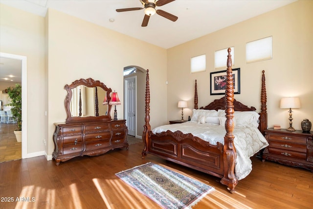 bedroom featuring ceiling fan, dark hardwood / wood-style flooring, and ensuite bath