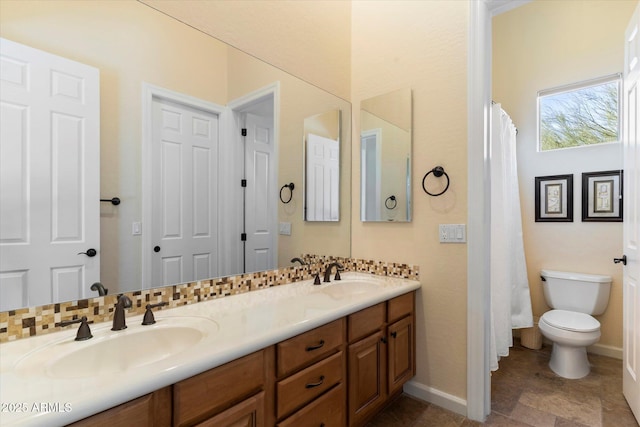 bathroom with vanity, toilet, decorative backsplash, and a shower with shower curtain