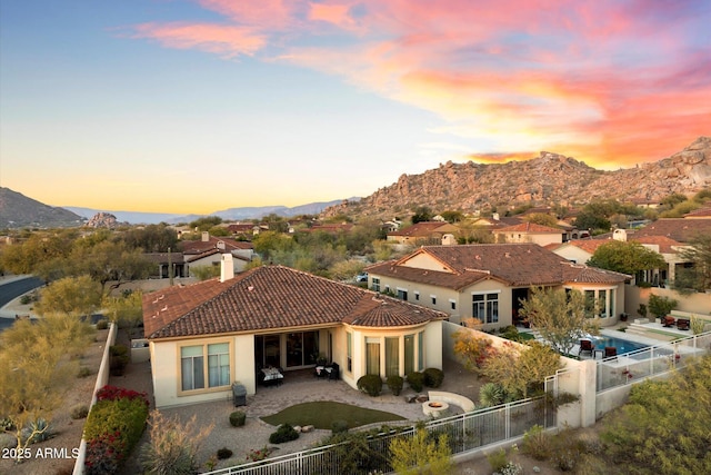 exterior space with a mountain view and a patio area