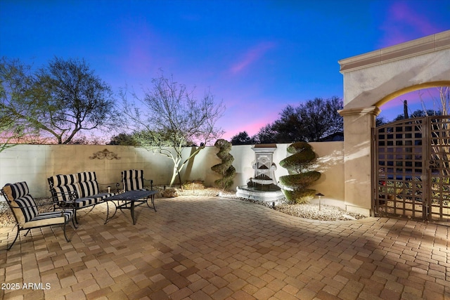 view of patio terrace at dusk