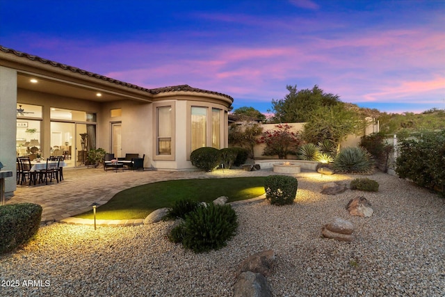 yard at dusk featuring a patio area