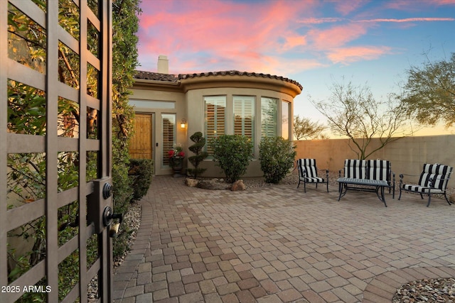 view of patio terrace at dusk