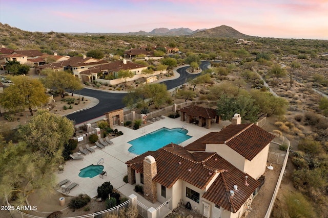 aerial view at dusk featuring a mountain view