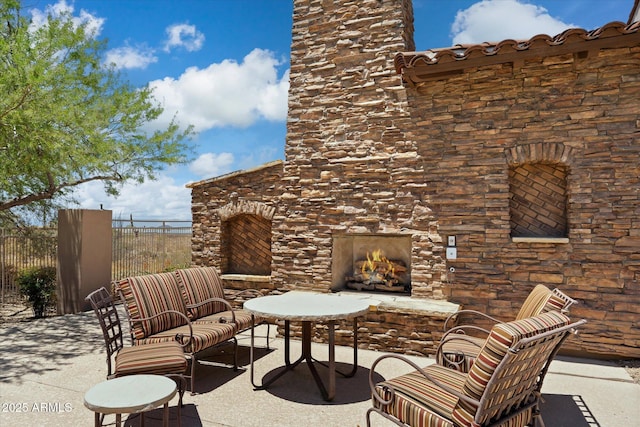 view of patio / terrace with an outdoor stone fireplace