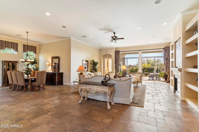 living room featuring ceiling fan and ornamental molding