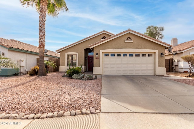 mediterranean / spanish house featuring a garage