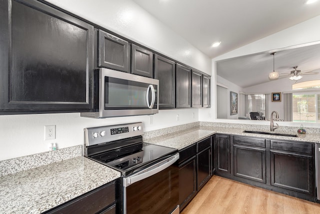 kitchen with sink, light hardwood / wood-style flooring, vaulted ceiling, ceiling fan, and stainless steel appliances