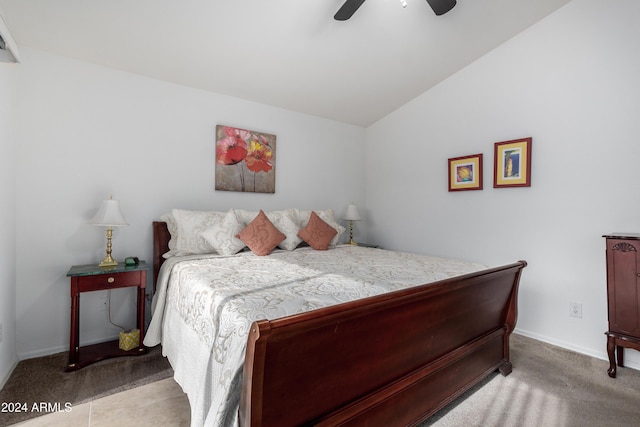 bedroom with ceiling fan, lofted ceiling, and light carpet