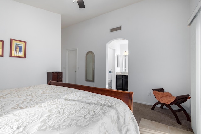 bedroom featuring ceiling fan, carpet floors, and ensuite bathroom