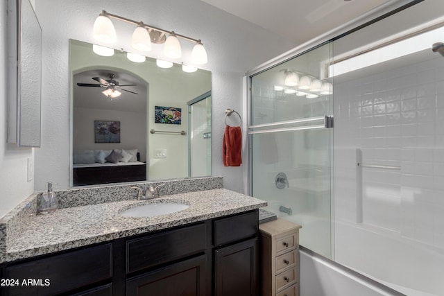 bathroom featuring shower / bath combination with glass door, ceiling fan, and vanity