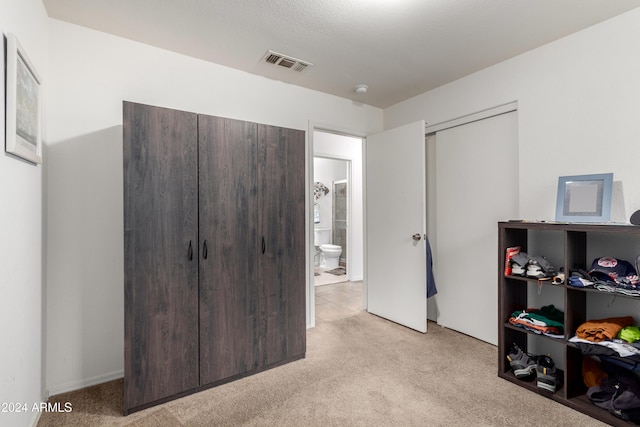 bedroom featuring light colored carpet