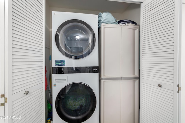 clothes washing area featuring stacked washer / drying machine