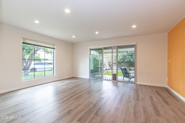 unfurnished room with recessed lighting, baseboards, and light wood-style floors