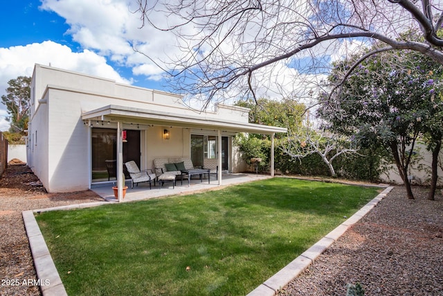 back of house with a patio area, a lawn, fence, and stucco siding