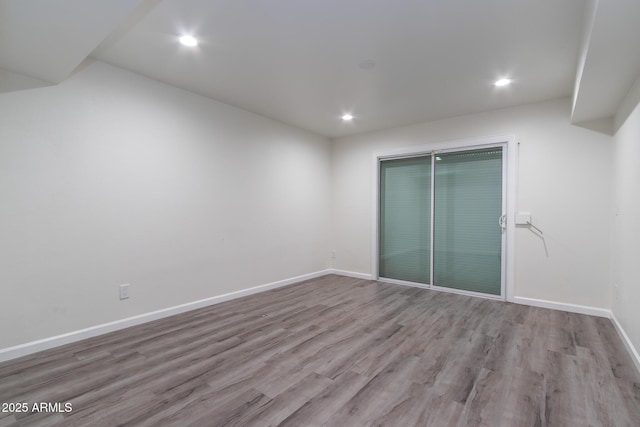 unfurnished bedroom featuring a closet, baseboards, and wood finished floors